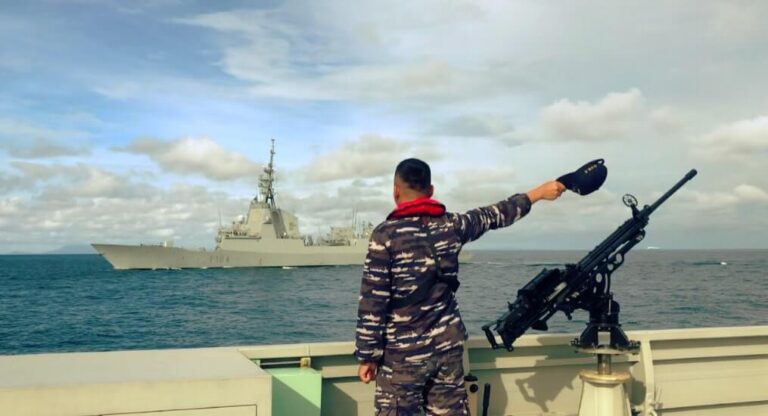 Prajurit TNI AL memberi isyarat ke fregat Spanyol di laut.